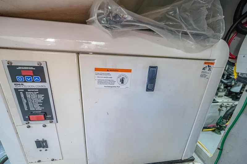 Coastal Fogg Yacht Photos Pics Engine room of 2006 Mainship 34 Trawler with control panel and warning labels.