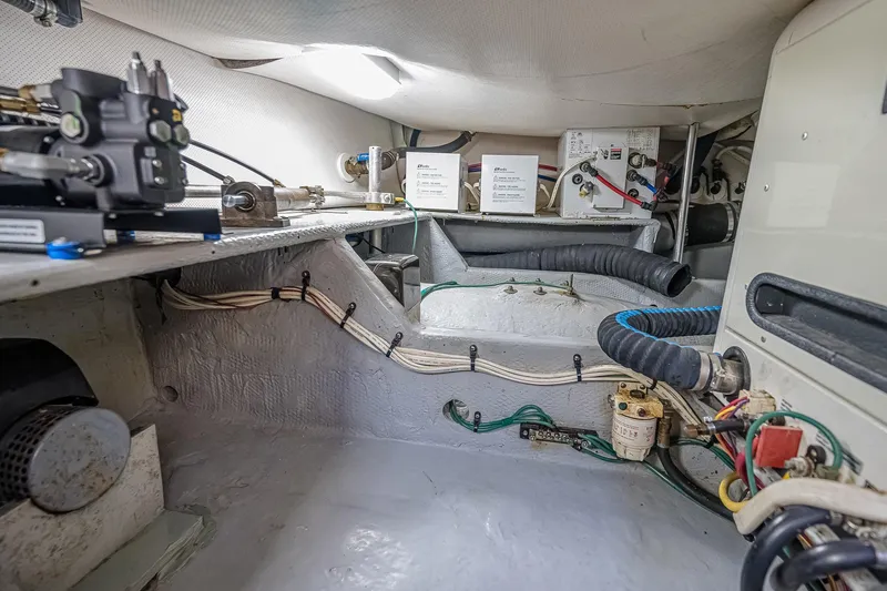 Coastal Fogg Yacht Photos Pics Engine room of 2006 Mainship 34 Trawler, showcasing mechanical components and wiring.