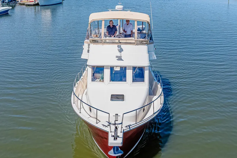 Coastal Fogg Yacht Photos Pics 2006 Mainship 34 Trawler cruising on calm water, viewed from the front.