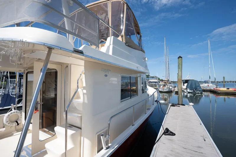 Coastal Fogg Yacht Photos Pics 2006 Mainship 34 Trawler docked at marina under clear blue sky.