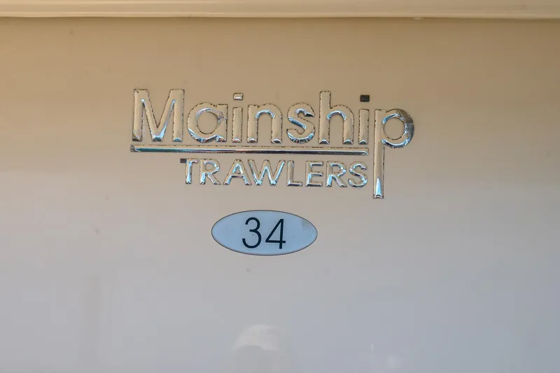 Coastal Fogg Yacht Photos Pics Mainship 34 Trawler 2006 logo on boat exterior.