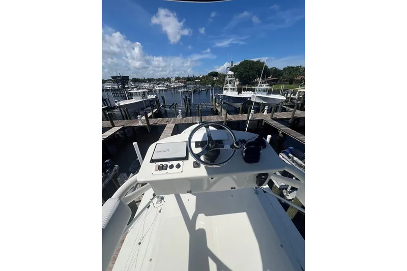 Five Wahoos Yacht Photos Pics Helm of 2015 HCB 42 Siesta boat docked at marina under blue sky.