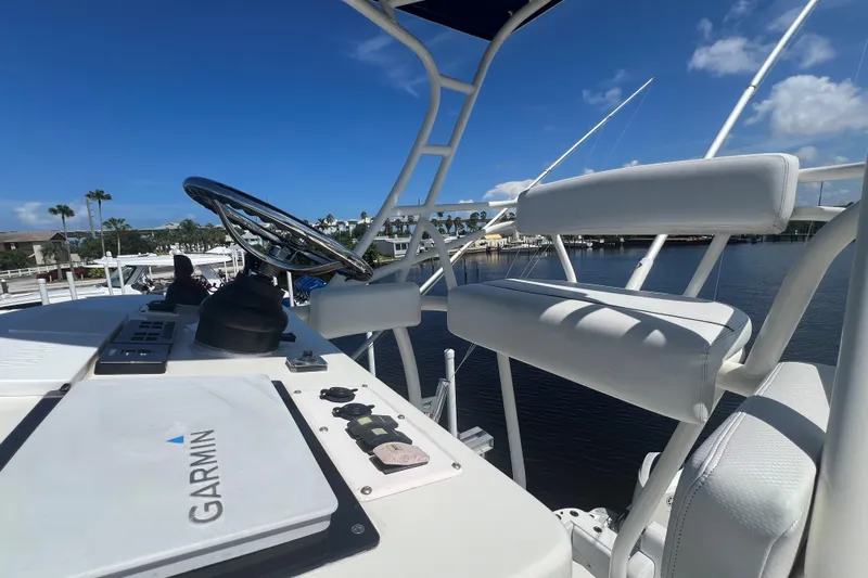 Five Wahoos Yacht Photos Pics 2015 HCB 42 Siesta boat helm with Garmin navigation, white seating, and clear blue sky.
