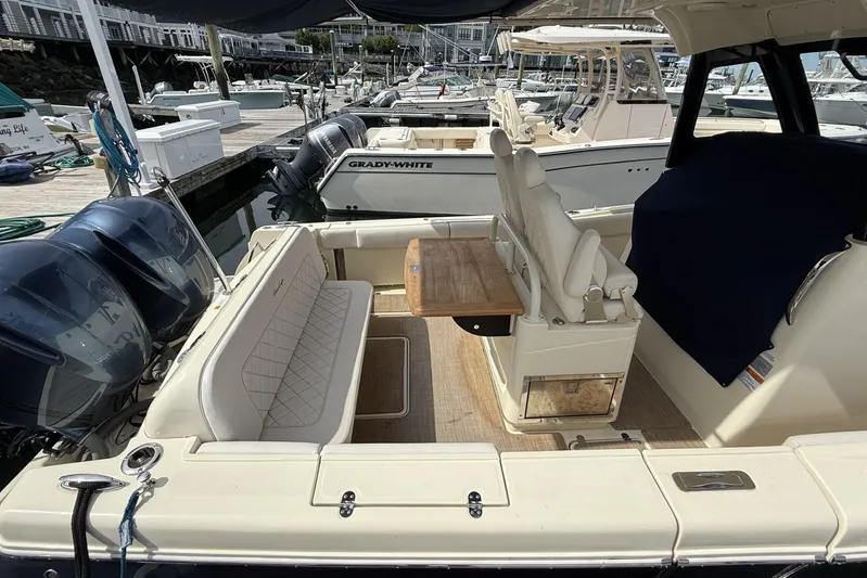  Yacht Photos Pics 2019 Chris-Craft Catalina 30 boat interior with seating and table at marina.