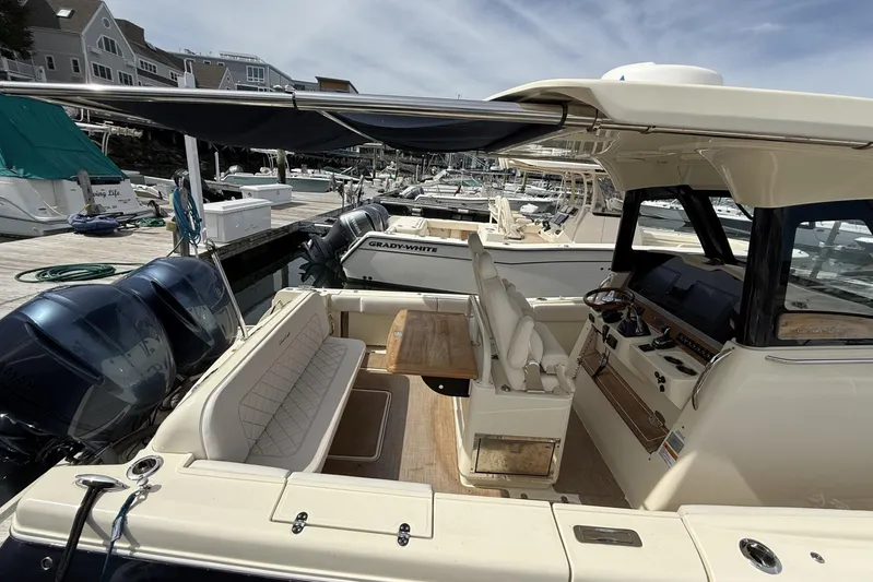  Yacht Photos Pics 2019 Chris-Craft Catalina 30 boat interior at marina, featuring seating and control panel.