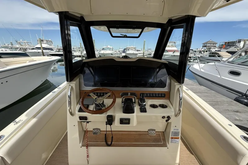  Yacht Photos Pics 2019 Chris-Craft Catalina 30 helm with steering wheel and controls, docked at marina.