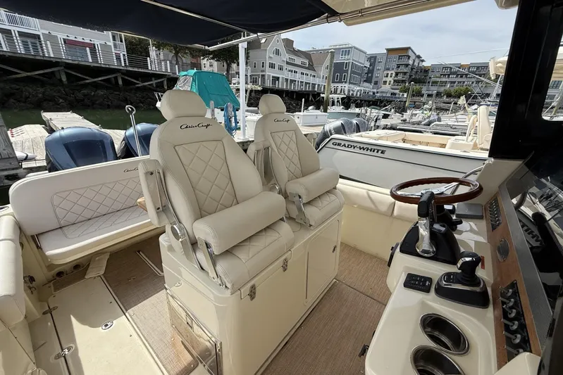  Yacht Photos Pics 2019 Chris-Craft Catalina 30 boat interior with luxurious seating and control panel.