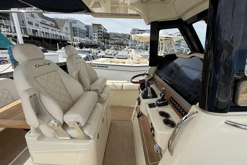  Yacht Photos Pics Interior of 2019 Chris-Craft Catalina 30 boat with luxurious seating and modern dashboard.