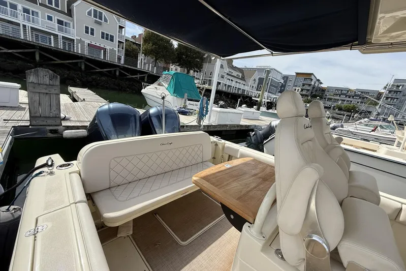  Yacht Photos Pics 2019 Chris-Craft Catalina 30 interior with seating and table, docked at a marina.