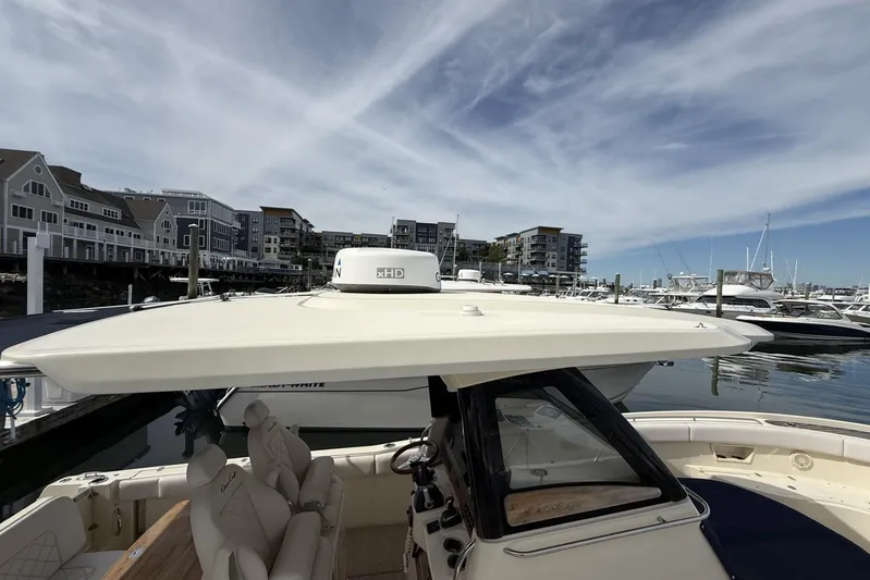  Yacht Photos Pics 2019 Chris-Craft Catalina 30 docked at a marina with modern buildings in the background.