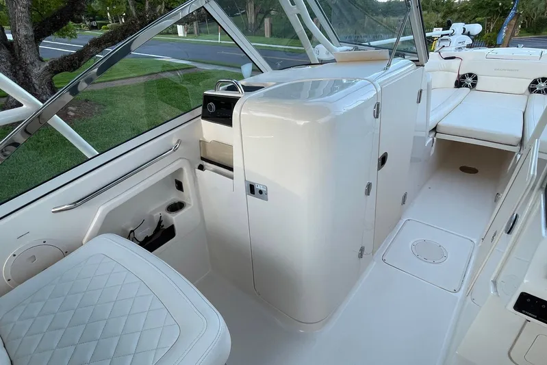  Yacht Photos Pics 2021 Grady-White Freedom 275 boat interior with seating and storage compartments.