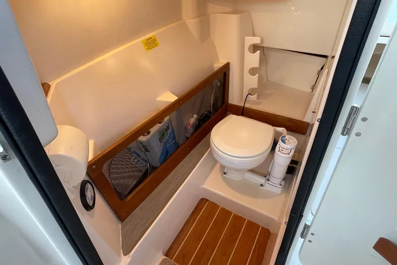  Yacht Photos Pics 2021 Grady-White Freedom 275 boat bathroom with toilet and storage area.