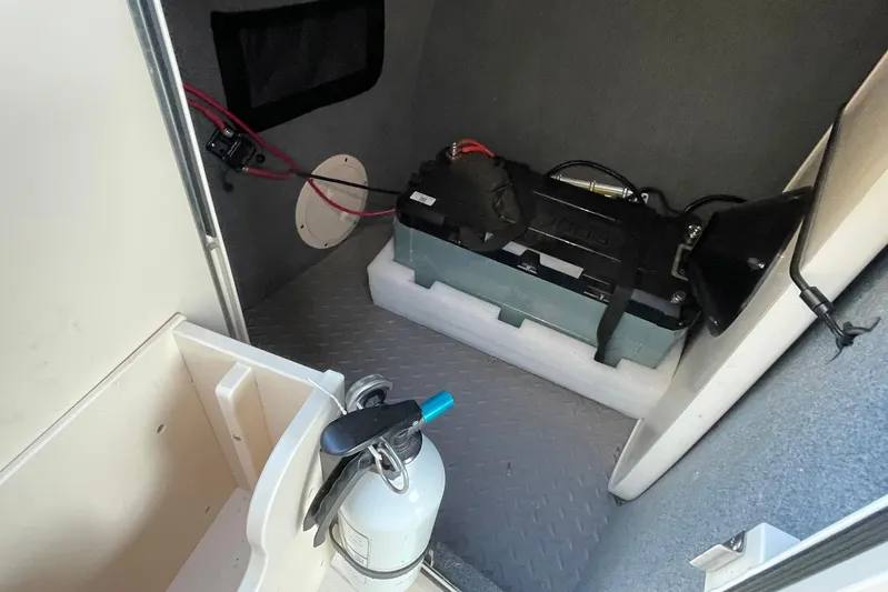  Yacht Photos Pics Interior of a 2021 Grady-White Freedom 275 boat showing a battery and fire extinguisher.