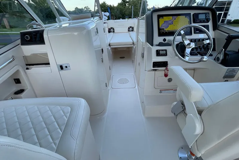  Yacht Photos Pics 2021 Grady-White Freedom 275 boat interior with steering wheel and navigation system.