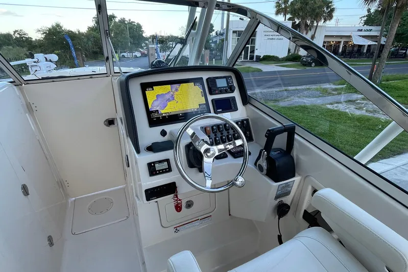  Yacht Photos Pics 2021 Grady-White Freedom 275 boat helm with navigation display and steering wheel.