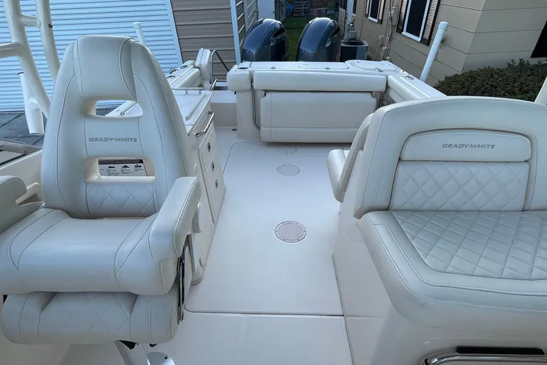  Yacht Photos Pics 2021 Grady-White Freedom 275 boat interior with luxurious seating and dual engines.