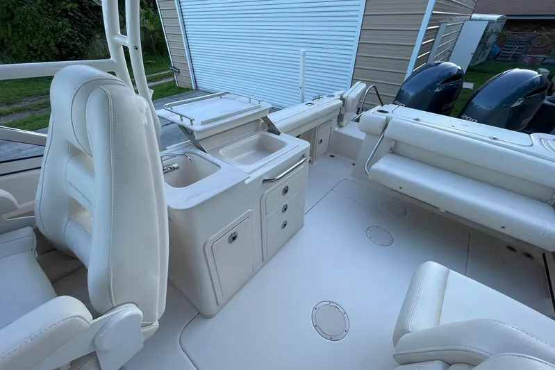  Yacht Photos Pics 2021 Grady-White Freedom 275 boat interior with seating and dual engines.