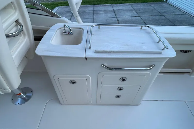  Yacht Photos Pics 2021 Grady-White Freedom 275 boat interior with sink and storage compartments.