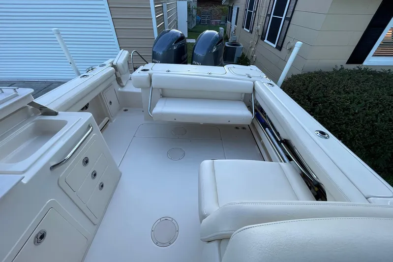  Yacht Photos Pics 2021 Grady-White Freedom 275 boat interior with seating and storage compartments.