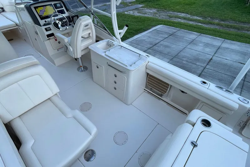  Yacht Photos Pics 2021 Grady-White Freedom 275 boat interior with helm, seating, and storage compartments.