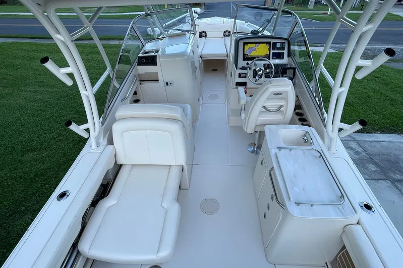  Yacht Photos Pics 2021 Grady-White Freedom 275 boat interior with seating, steering, and navigation system.