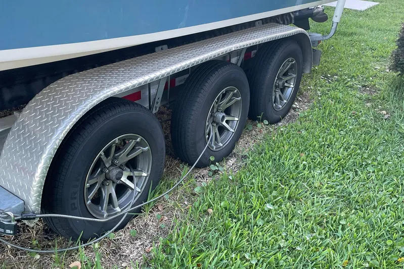  Yacht Photos Pics Trailer with triple axles for 2021 Grady-White Freedom 275 boat on grass.