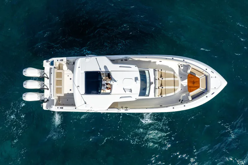 Gugui Yacht Photos Pics 2024 Boston Whaler 420 Outrage boat on clear blue water, aerial view.