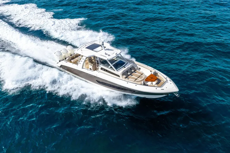 Gugui Yacht Photos Pics 2024 Boston Whaler 420 Outrage cruising on open blue ocean waters.
