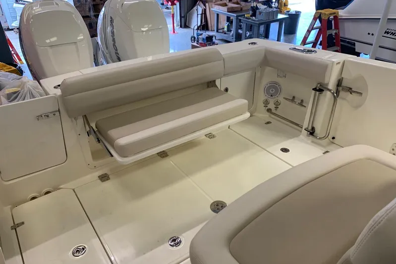  Yacht Photos Pics 2019 Boston Whaler 330 Outrage boat interior with seating and storage compartments.
