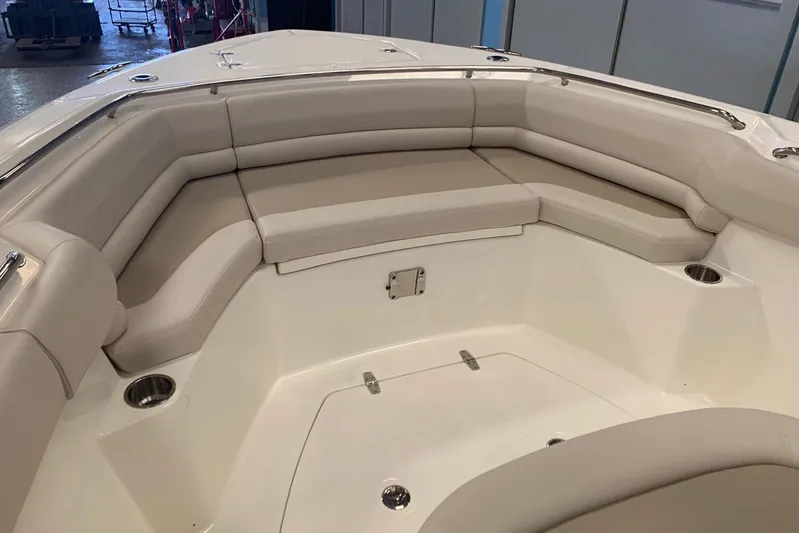  Yacht Photos Pics 2019 Boston Whaler 330 Outrage boat interior with cushioned seating and cup holders.