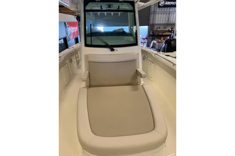  Yacht Photos Pics 2019 Boston Whaler 330 Outrage boat interior with cushioned seating and windshield.