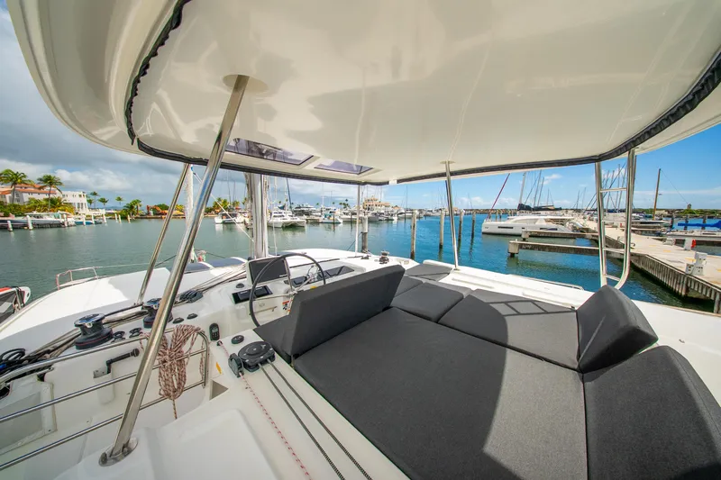 Dakiti Yacht Photos Pics 2023 Lagoon 46 yacht interior with marina view, featuring spacious seating and modern design.