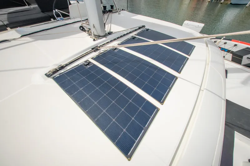 Dakiti Yacht Photos Pics 2023 Lagoon 46 yacht with solar panels on deck, docked at marina.