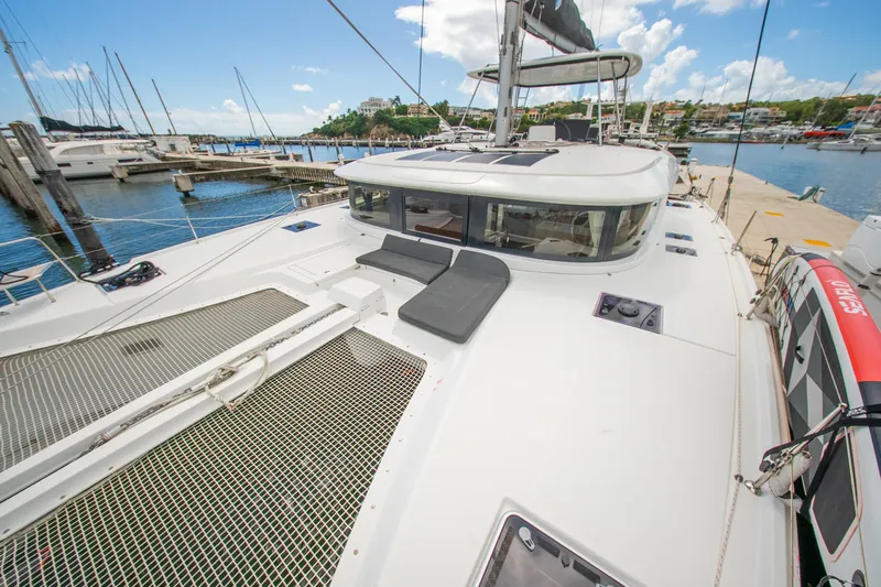 Dakiti Yacht Photos Pics 2023 Lagoon 46 catamaran docked at marina, featuring spacious deck and modern design.