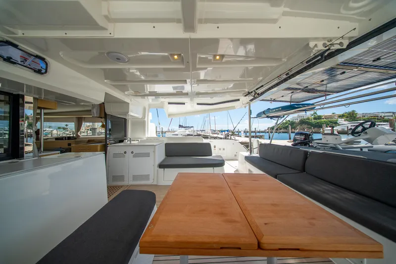 Dakiti Yacht Photos Pics Luxurious 2023 Lagoon 46 yacht interior with spacious seating and marina view.