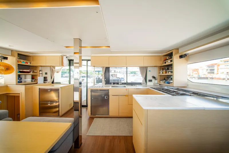 Dakiti Yacht Photos Pics Modern interior of 2023 Lagoon 46 yacht with spacious kitchen and sleek design.