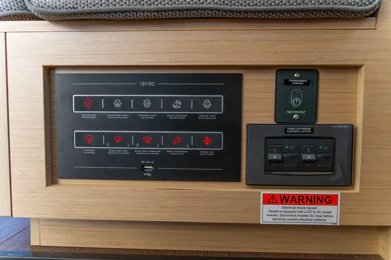 Dakiti Yacht Photos Pics Control panel of 2023 Lagoon 46 yacht with electrical system switches and warning label.