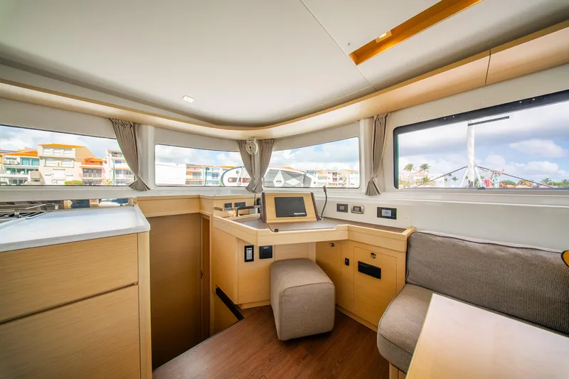 Dakiti Yacht Photos Pics Interior of 2023 Lagoon 46 yacht, featuring modern navigation station and panoramic windows.