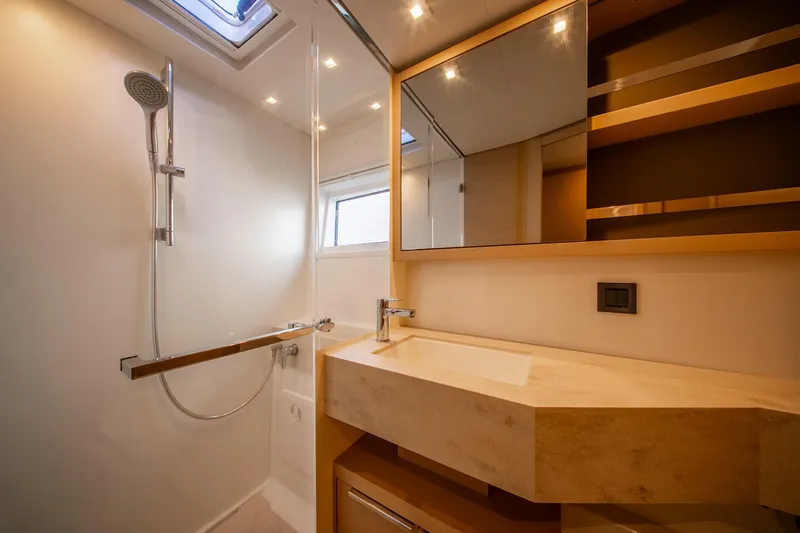 Dakiti Yacht Photos Pics Luxurious bathroom in 2023 Lagoon 46 yacht with modern fixtures and elegant design.