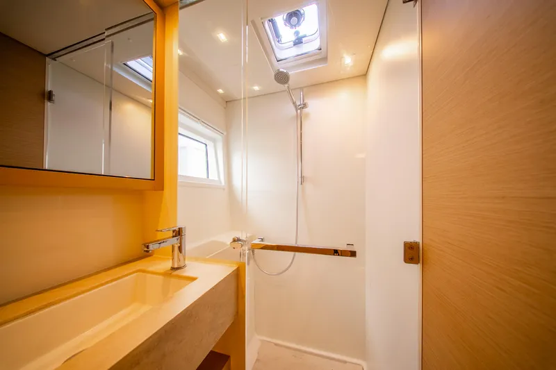 Dakiti Yacht Photos Pics Modern bathroom interior on 2023 Lagoon 46 yacht, featuring sleek shower and vanity.