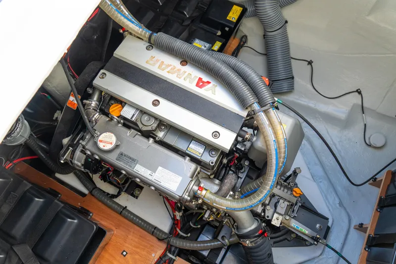 Dakiti Yacht Photos Pics Engine compartment of 2023 Lagoon 46 yacht, featuring a Yanmar engine with visible hoses and components.
