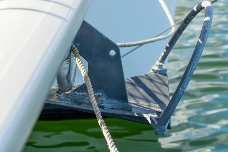 Dakiti Yacht Photos Pics Close-up of 2023 Lagoon 46 catamaran anchor detail with rope in water.