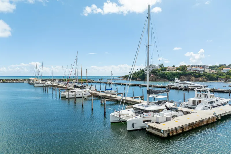 Dakiti Yacht Photos Pics Marina with 2023 Lagoon 46 catamarans docked under a clear blue sky.