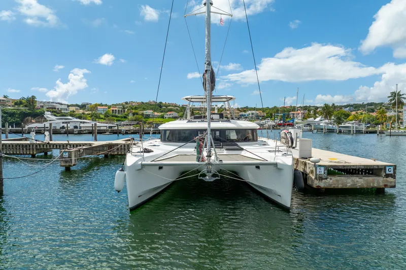 Dakiti Yacht Photos Pics 2023 Lagoon 46 catamaran docked in a sunny marina, surrounded by scenic waterfront views.