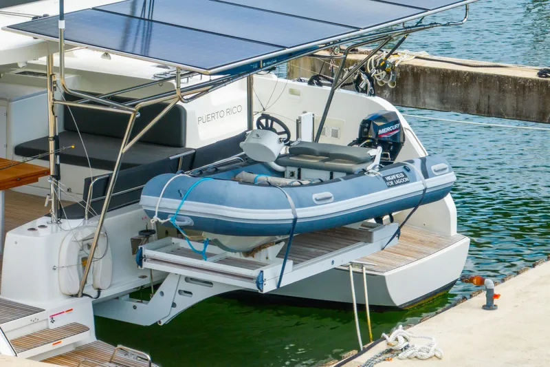 Dakiti Yacht Photos Pics 2023 Lagoon 46 catamaran with solar panels and dinghy, docked in Puerto Rico.