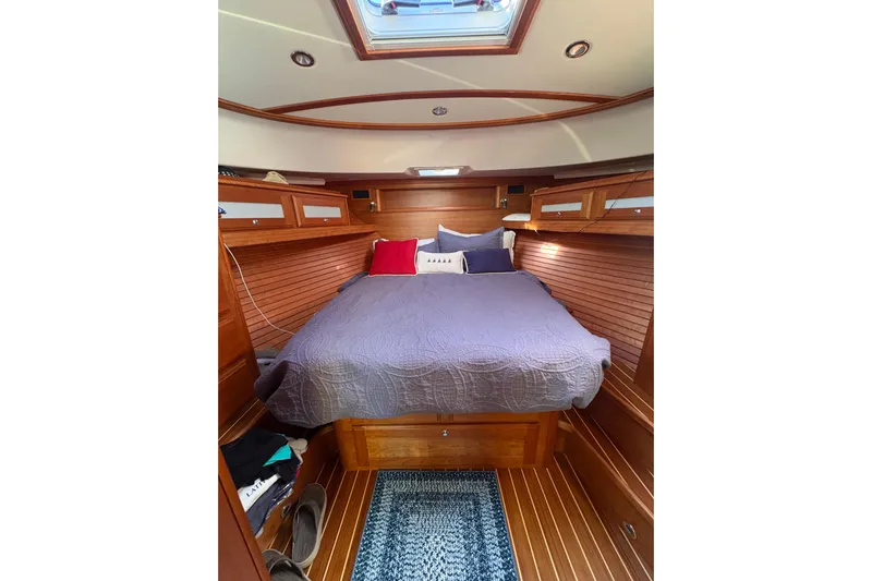  Yacht Photos Pics Luxurious cabin interior of 2023 Sabre 45 Salon Express with cozy bed and wooden finish.
