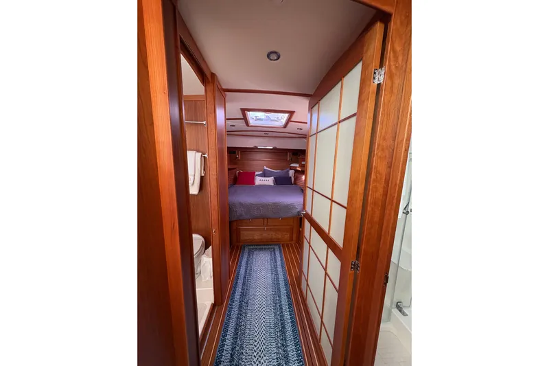  Yacht Photos Pics Luxurious interior of 2023 Sabre 45 Salon Express yacht with wood paneling and cozy bedroom.