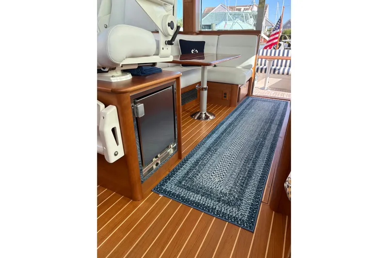  Yacht Photos Pics Interior of 2023 Sabre 45 Salon Express yacht with elegant seating and wooden flooring.