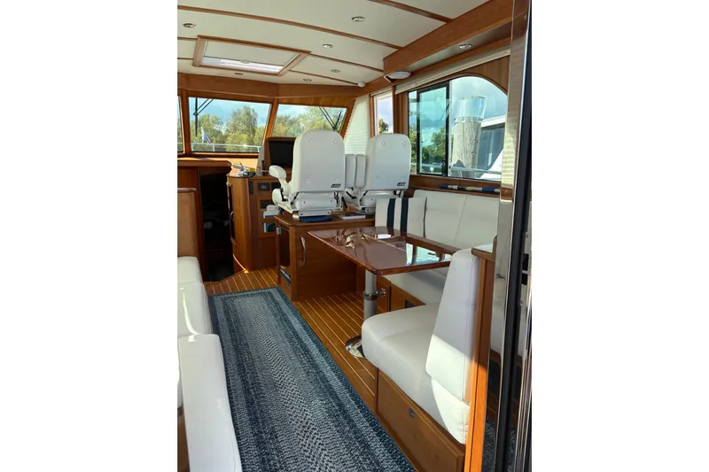  Yacht Photos Pics Interior of 2023 Sabre 45 Salon Express yacht, featuring elegant seating and wooden finishes.