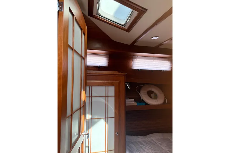  Yacht Photos Pics Interior of 2023 Sabre 45 Salon Express yacht with wooden door and skylight.